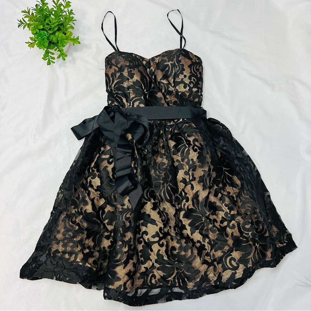 Black and gold flared hem babydoll dress with bow detail